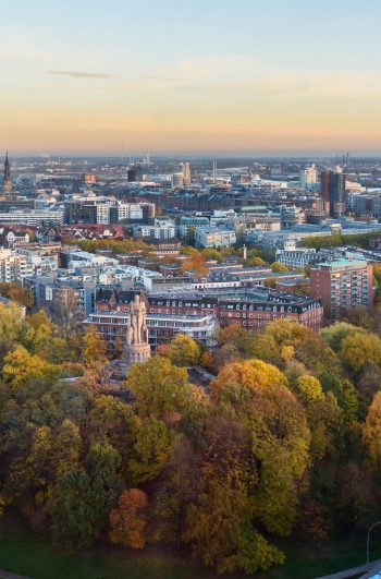 View of Hamburg with Michel, harbor, and New Elbphilharmony on sunset in autumn. Germany